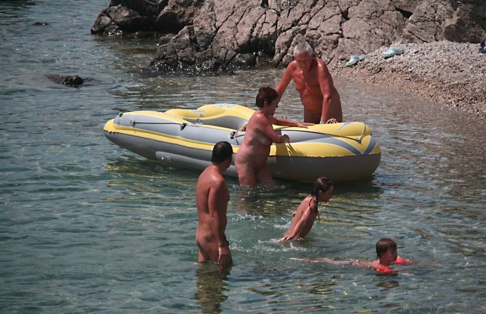 Lone Nudist in Yellow Boat photos - nudism and naturism
