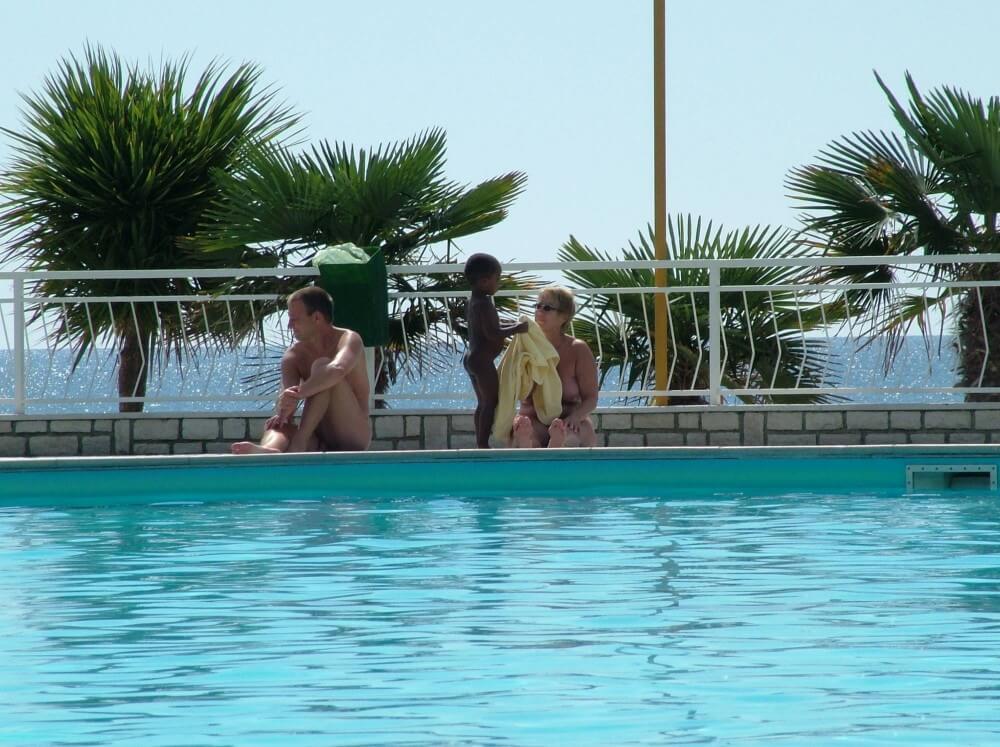 Photo of naturists in an outdoor pool - nudism and naturism